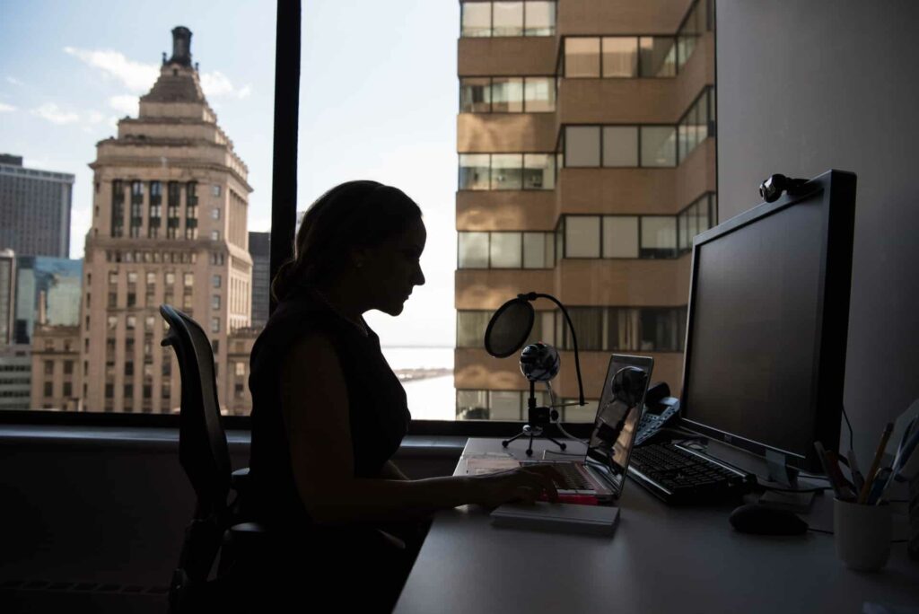 woman at laptop with skyline view 2